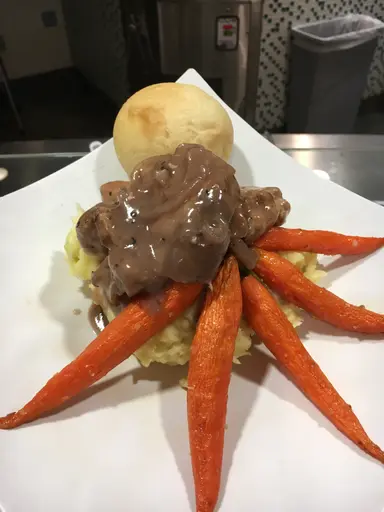 Braised lamb with mashed potato and roasted carrots