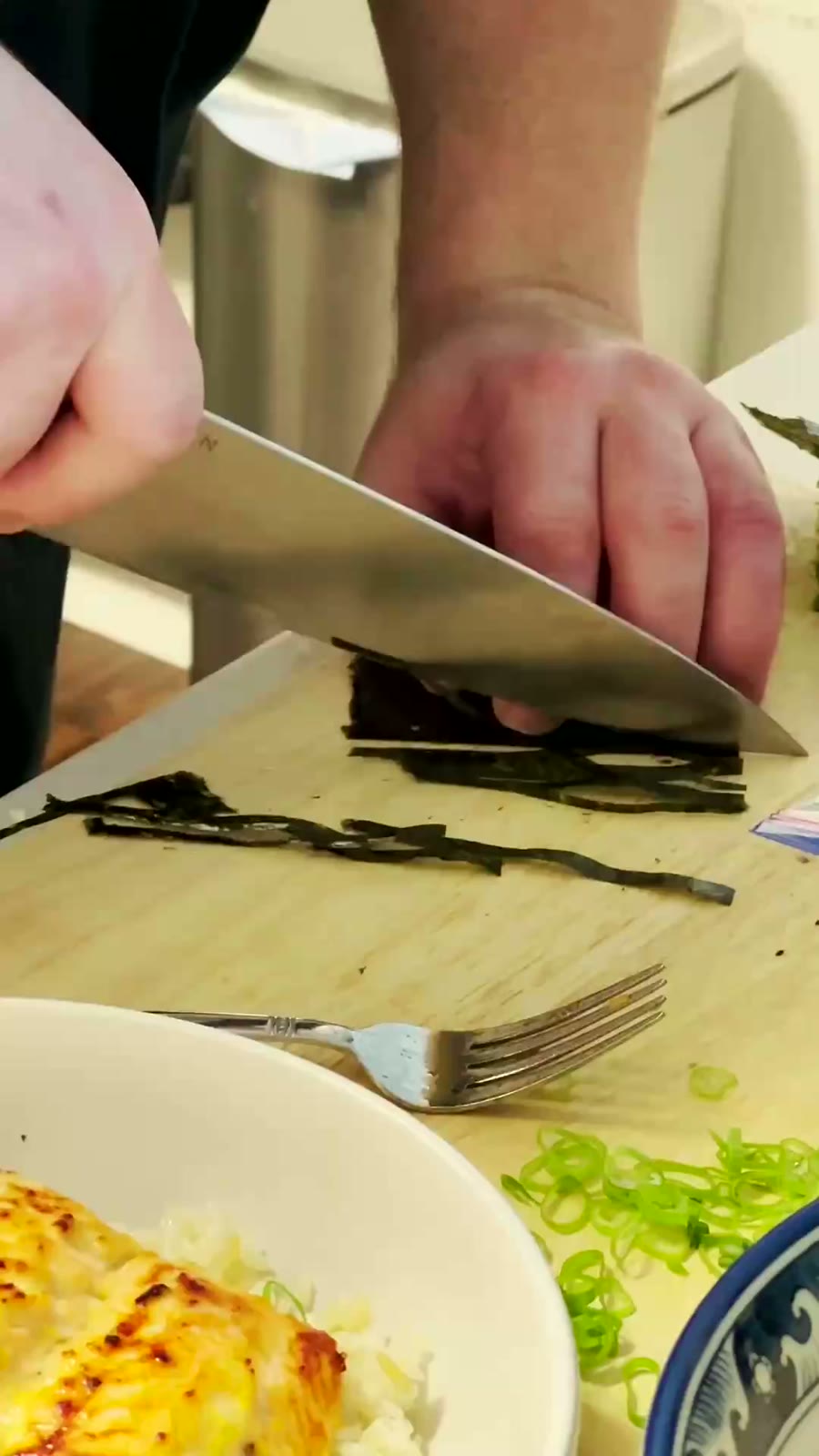 A chef slicing nori